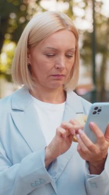 Hüsrana uğramış iş kadını, şehir caddesinde duran cep telefonundan kredi kartını kontrol ederken dolandırıcılığı keşfetti. Üzgün kadın işveren aldatma kurbanı oldu, hesabından para çalındı..