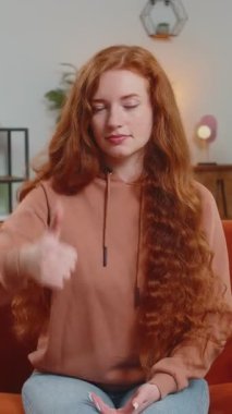 Hoşlanmamak. Mutsuz bir kadının tabela hareketi, hoşnutsuzluğu, tatminsizliği ve evde yapılan kötü işleri gösteren portresi. Memnun olmayan kızıl saçlı kız oturma odasında, kanepede..