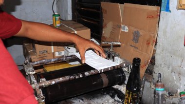 Workers making white license plates for a new type of motor vehicle, Pekalongan, Indonesia, October 17, 2022