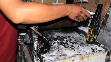 Workers making white license plates for a new type of motor vehicle, Pekalongan, Indonesia, October 17, 2022