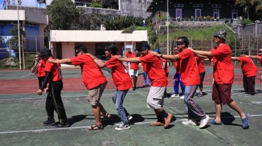 group of people are playing team working Game to build a teamwork, Semarang Indonesia, December 17, 2022