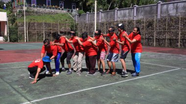 group of people are playing team working Game to build a teamwork, Semarang Indonesia, December 17, 2022