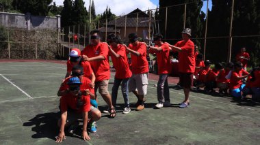 group of people are playing team working Game to build a teamwork, Semarang Indonesia, December 17, 2022