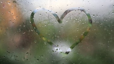 Romantic I love you written on fogged or frozen window glass, close up sign