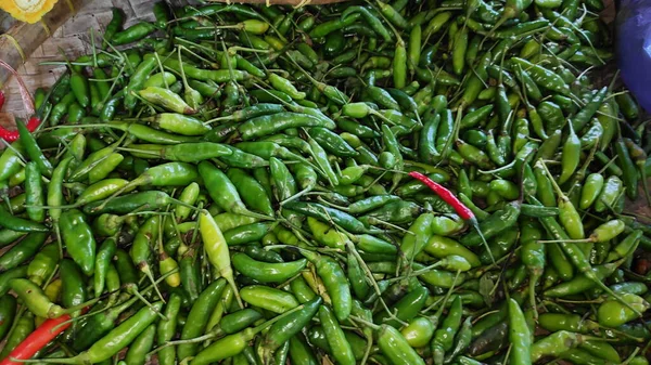 piles of spicy cayenne pepper in containers sold in traditional markets