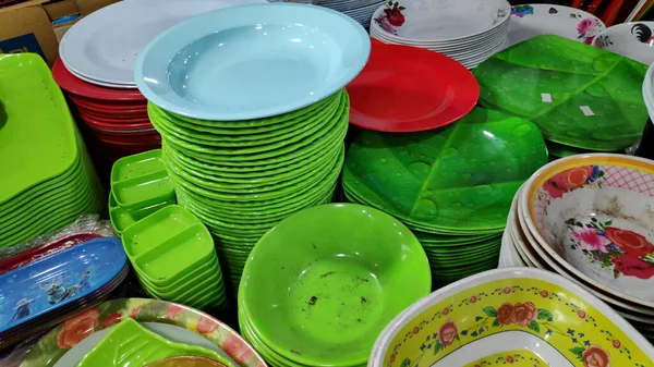 Cheap plastic household items for sale on the market close up Environment pollution concept
