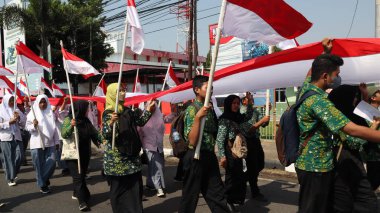 28 Ağustos 2023 'te Pekalongan Endonezya' da düzenlenen Bağımsızlık Günü Karnavalı sırasında Endonezya kırmızı ve beyaz bayrak taşıyan birlikler