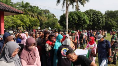 8 Mart 2024 'te hükümet Pekalongan Endonezya' nın ucuz temel ihtiyaçlarını satın almak için kuyrukta bekleyenler