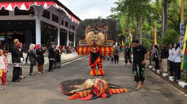 Geleneksel dansın adı REOG, tavus kuşu kuyruğu tüyleriyle süslenmiş büyük kaplan gibi maskeli dansçılar, Batang Endonezya 25 Nisan 2024