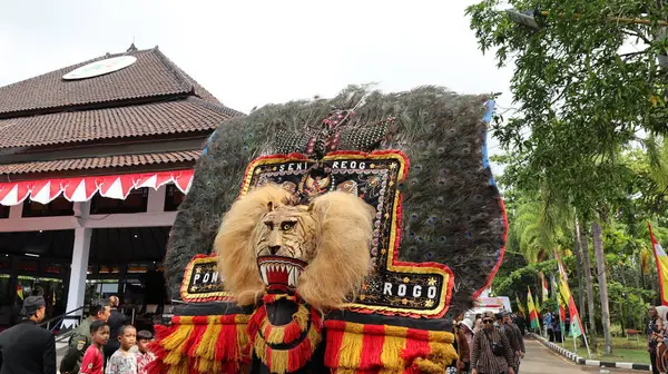 stock image Traditional Dance from is called REOG, masked dancers resembling large tiger decorated with peacock tail feathers, Batang Indonesia April 25 2024