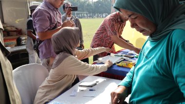 Geleneksel bir alışveriş yeri olan Pekalongan 'da 14 Haziran 2024' te alışveriş yapan sakinlerin portresi