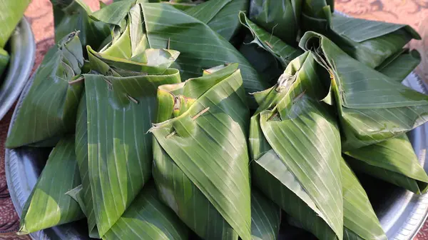 stock image stack of traditional wrapped rice in banana leaves, megono rice wrapped in banana leaves