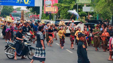 Cremation ceremony or Ngaben in Bali. People carry a wooden container (a temple-like structure with a coffin on top) to the grave. clipart