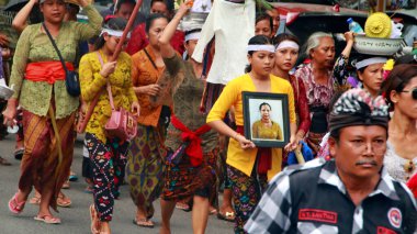 Cremation ceremony or Ngaben in Bali. People carry a wooden container (a temple-like structure with a coffin on top) to the grave. clipart