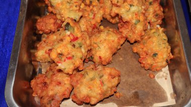 Bakwan Jagung or corn fritters is Indonesian traditional food. Savory snack made of corn, egg, flour, spring onion, pepper and salt clipart