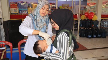 Toddlers take part in the immunization program in the context of World Immunization Week at Posyandu, Batang Indonesia August 6 2024 clipart