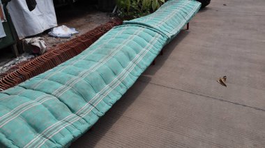 Traditional Javanese mattress or Kapok mattresses, made from Ceiba pentandra fibers being dried in the sun clipart