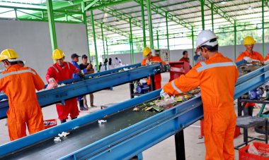 Geri dönüşümlü materyalleri sınıflandırmak için atık işleme fabrikasında çalışırken güvenlik kıyafeti ve kask giyen işçilerin portresi, Pekalongan Endonezya 10 Ocak 2025