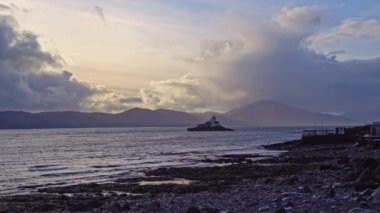 Aerial panorama view of the historic Fenit Lighthouse in Tralee Bay, beautiful clouds, sunset. High quality 4k footage