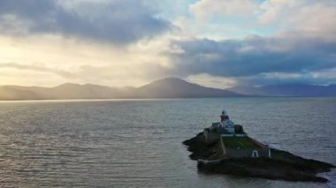 Aerial panorama view of the historic Fenit Lighthouse in Tralee Bay, beautiful clouds, sunset. High quality 4k footage