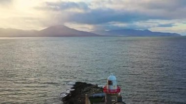 Aerial panorama view of the historic Fenit Lighthouse in Tralee Bay, beautiful clouds, sunset. High quality 4k footage