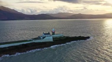 Aerial panorama view of the historic Fenit Lighthouse in Tralee Bay, beautiful clouds, sunset. High quality 4k footage