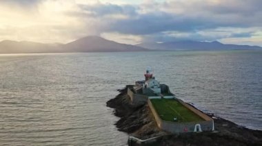 Aerial panorama view of the historic Fenit Lighthouse in Tralee Bay, beautiful clouds, sunset. High quality 4k footage