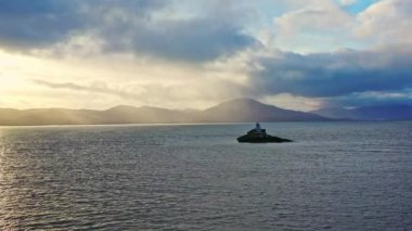 Aerial panorama view of the historic Fenit Lighthouse in Tralee Bay, beautiful clouds, sunset. High quality 4k footage