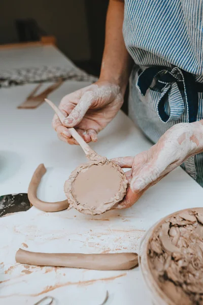 stock image Close up of female hands working with clay making a cup in a workshop. Selective focus.