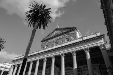 The Papal Basilica of Saint Paul Outside the Walls is one of the four papal basilicas of Rome. It rises along the Via Ostiense, in the district of the same name, near the left bank of the Tiber.