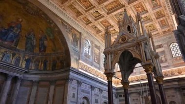 The Papal Basilica of Saint Paul Outside the Walls is one of the four papal basilicas of Rome. It rises along the Via Ostiense, in the district of the same name, near the left bank of the Tiber.