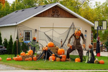 Homeowners of the community dressed up their houses and yard with scary Halloween decorations for 2022. clipart