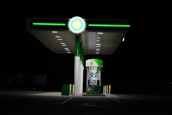 New Lisbon, Wisconsin USA - April 15th, 2022: BP fuel station glows at night servicing the community.