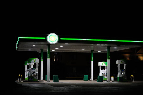 New Lisbon, Wisconsin USA - April 15th, 2022: BP fuel station glows at night servicing the community.
