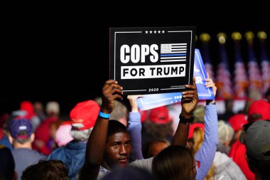 Mosinee, Wisconsin / USA - September 17th, 2020: Donald trump supporters holding up signs make america great again, pro life, cops for trump, peaceful protester, and 4 more years at president rally. clipart