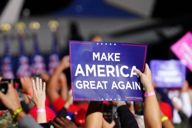 Mosinee, Wisconsin / USA - September 17th, 2020: Donald trump supporters holding up signs make america great again, pro life, cops for trump, peaceful protester, and 4 more years at president rally. clipart