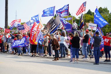 Manitowoc, Wisconsin / USA - September 21th, 2020: President trump and vice president mike pence supporters and joe biden and kamala harris supporters rallied together outside aluminum foundry. clipart