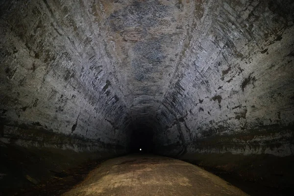 Inside an old train tunnel that is now a bike trail.