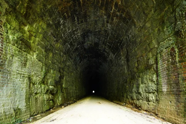 Inside an old train tunnel that is now a bike trail.