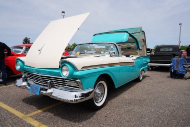 Wisconsin Dells, Wisconsin USA - May 21st, 2022: Turquoise Cream White 1957 Ford Retractable vintage car at Automotion car show clipart