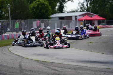 Dousman, Wisconsin USA - August 8th, 2019: go-kart drivers raced in national races at Badger Kart club Wolf Paving Raceway. clipart