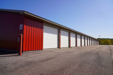 Red and Tan storage units holding the owner's property. clipart