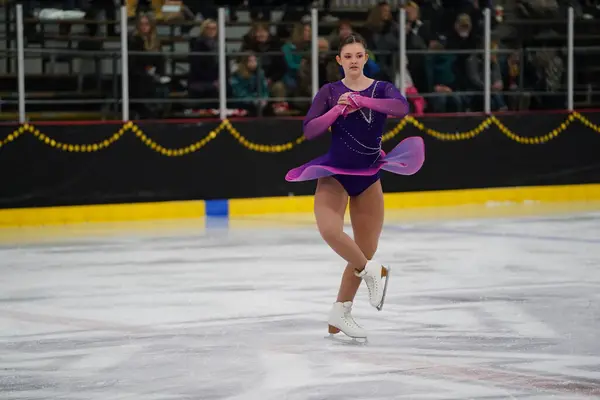 米国ウィスコンシン州モシニア 2021年2月26日 美しい紫色のドレスの若い白人ティーンエイジャーの女性がより悪い州の冬のゲームアイススケート競技に参加しました — ストック写真
