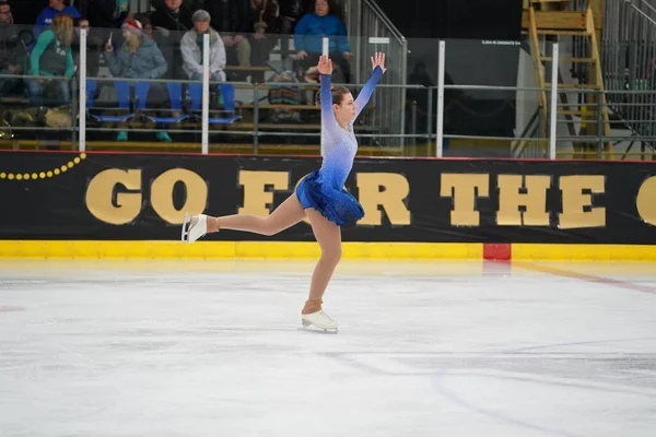 stock image Mosinee, Wisconsin USA - February 26th, 2021: Young adult female in a beautiful blue dress participated in badger state winter games ice skating competition