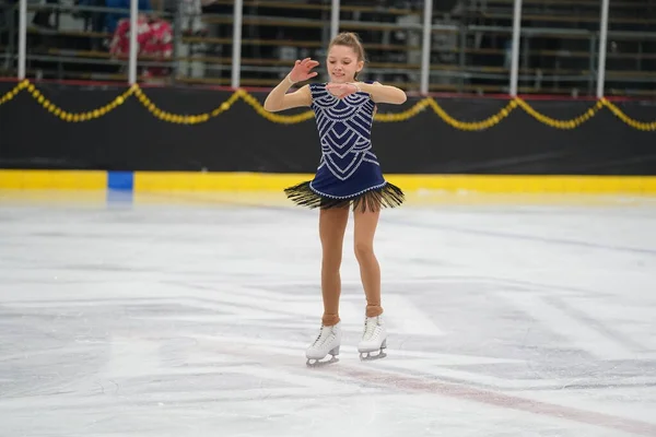 Stock image Mosinee, Wisconsin USA - February 26th, 2021: Young adult female in a beautiful blue dress participated in badger state winter games ice skating competition.