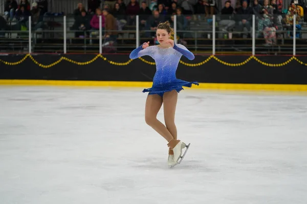 Stock image Mosinee, Wisconsin USA - February 26th, 2021: Young adult female in a beautiful blue dress participated in badger state winter games ice skating competition