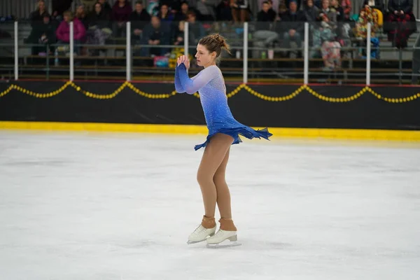 stock image Mosinee, Wisconsin USA - February 26th, 2021: Young adult female in a beautiful blue dress participated in badger state winter games ice skating competition