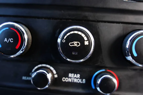 Temperature climate control system knobs on the center console inside of a truck in Fond du Lac, Wisconsin