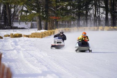 Hortonville, Wisconsin / ABD - 26 Ocak 2019: Kar motosikletli sürücüler donmuş buzlu göl üzerinde gezinirken eğleniyorlardı.