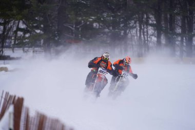 Hortonville, Wisconsin / ABD - 26 Ocak 2019: Toprak motosikletli sürücüler donmuş buzlu göl üzerinde gezinirken eğleniyorlardı